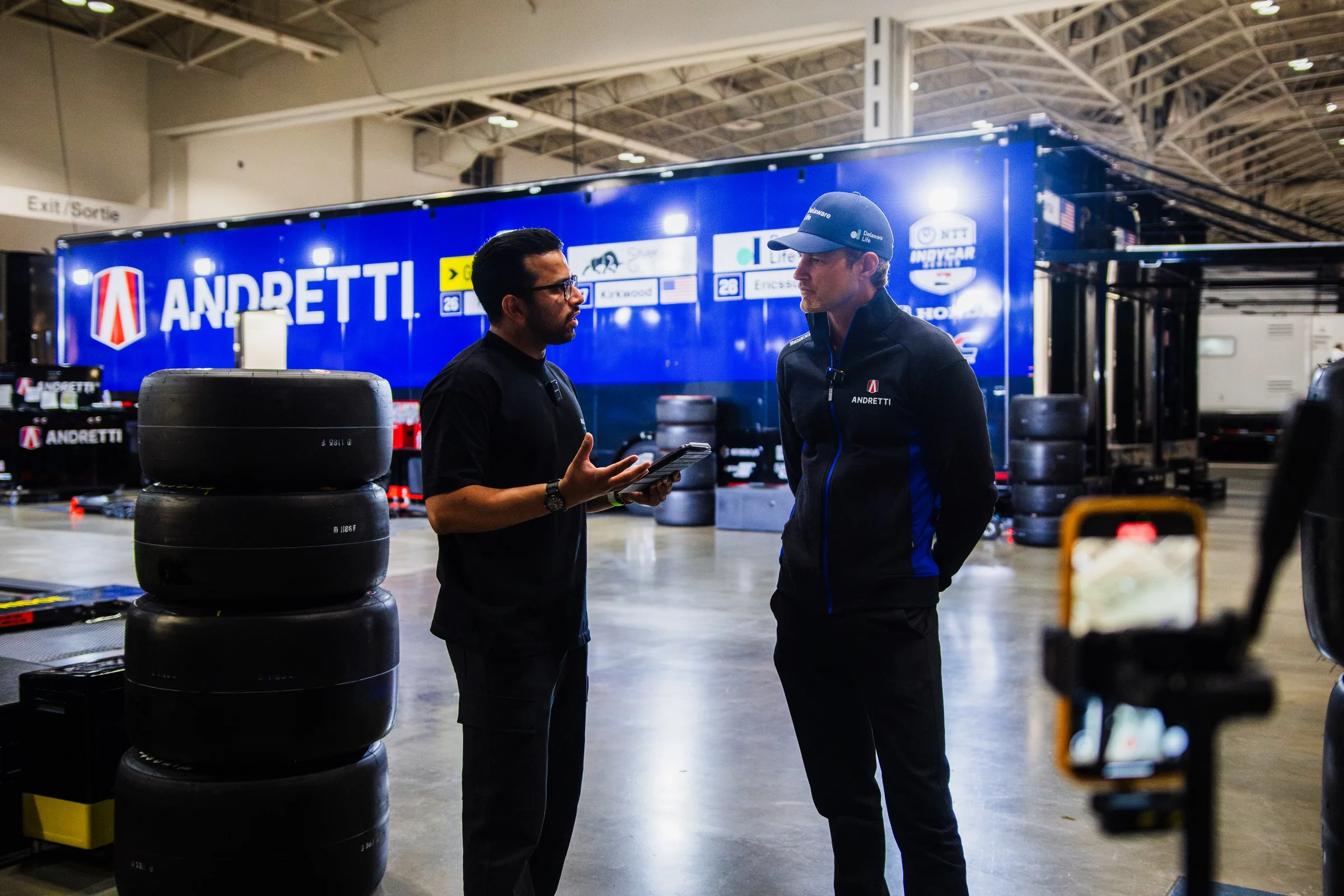 Sachin Jha interviewing an IndyCar driver in the paddock